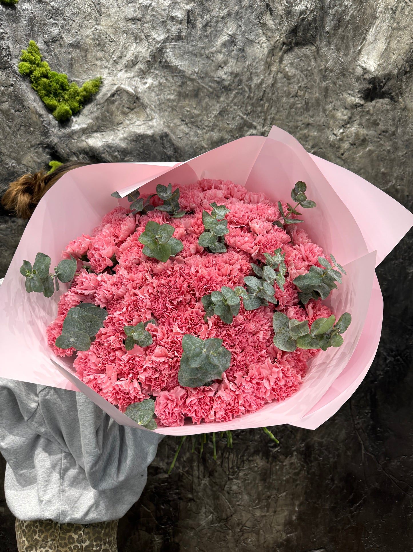 Bouquet of pink dianthuses and eucalyptus