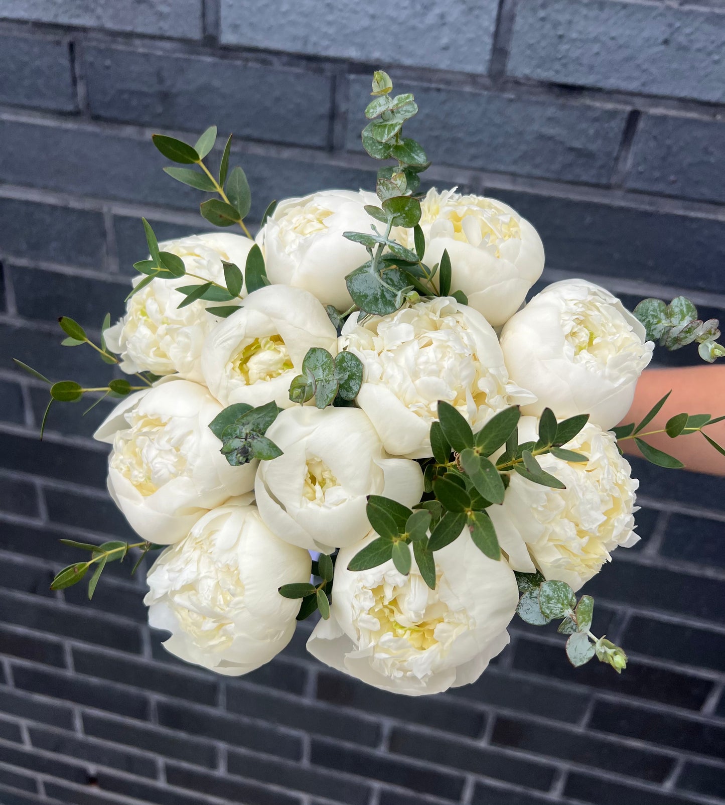 Wedding bouquet of white peonies & eucalyptus