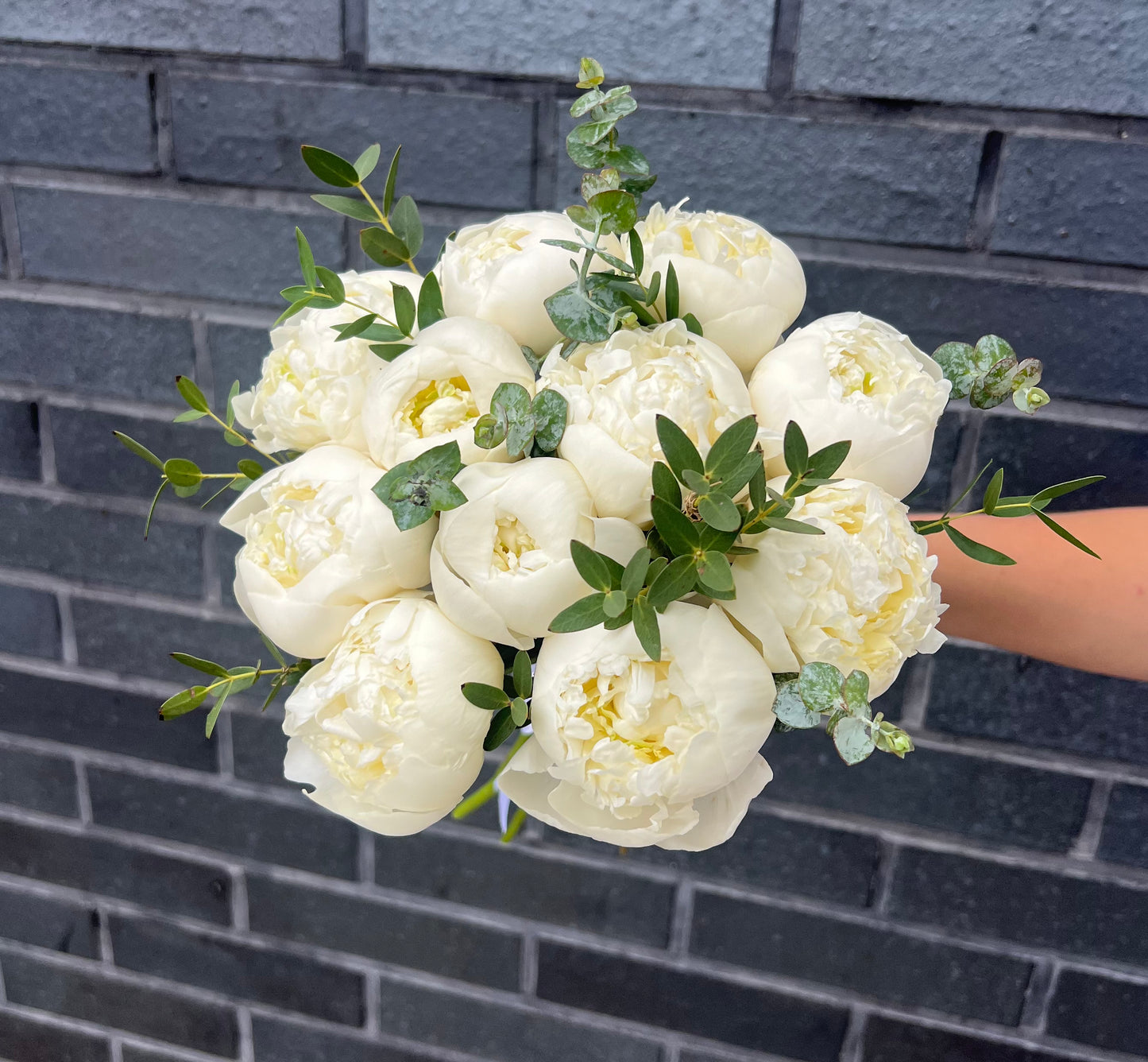 Wedding bouquet of white peonies & eucalyptus